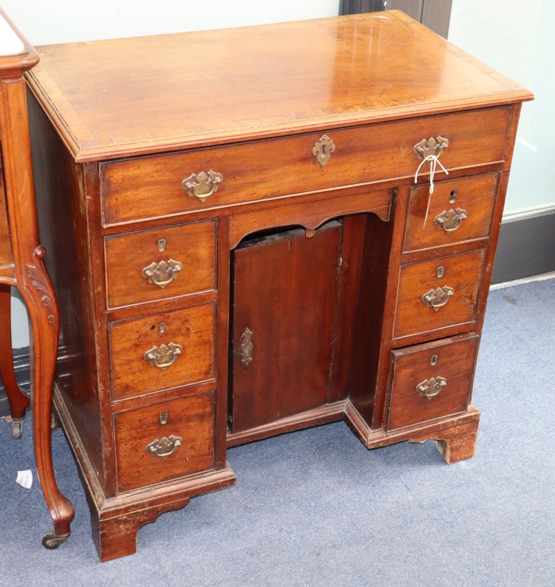 A George III mahogany kneehole desk, W.75cm., D.44cm., H.77cm.